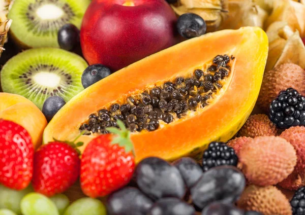 Friss nyers bio nyári bogyók és egzotikus gyümölcsök. Makró. Közelről. Ananász, papaya, szőlő, nektarin, narancs, sárgabarack, Kiwi, lychees, cseresznye és Physalis, málna. — Stock Fotó