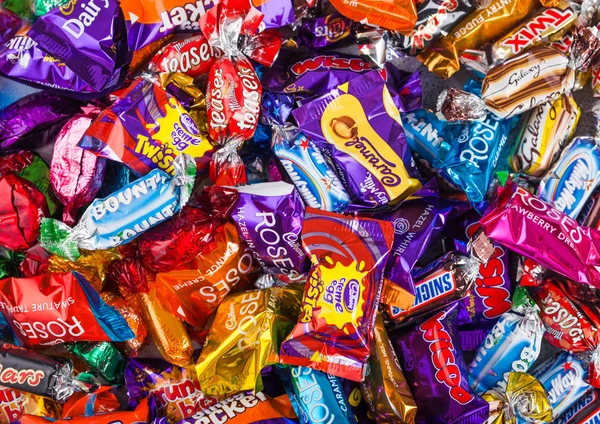 LONDON, UK - OCTOBER 10, 2019: Mix chocolate candies on white background. Quality Street, Celebrations, Roses and Heroes — Stock Photo, Image