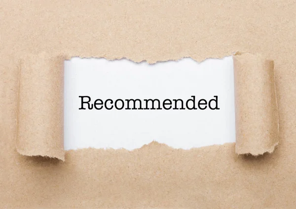 Recommended text appearing behind brown paper — Stock Photo, Image