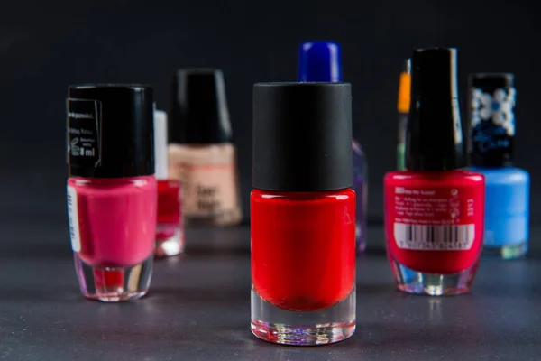 Coloured nail polish bottles on dark background