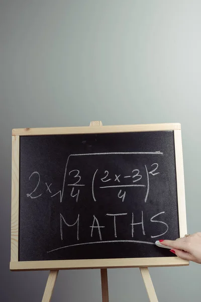 Math exercise on chalkboard