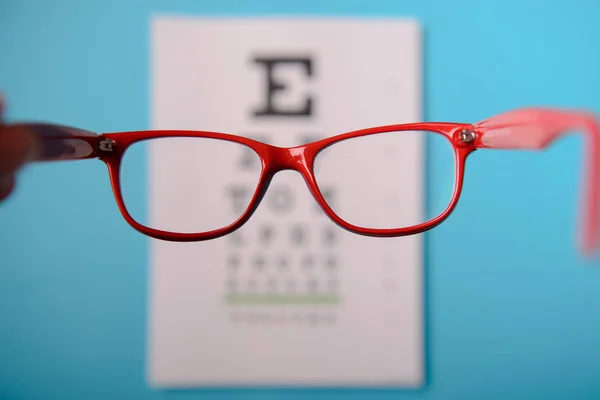 Glasögon liggande på snellen test diagram — Stockfoto