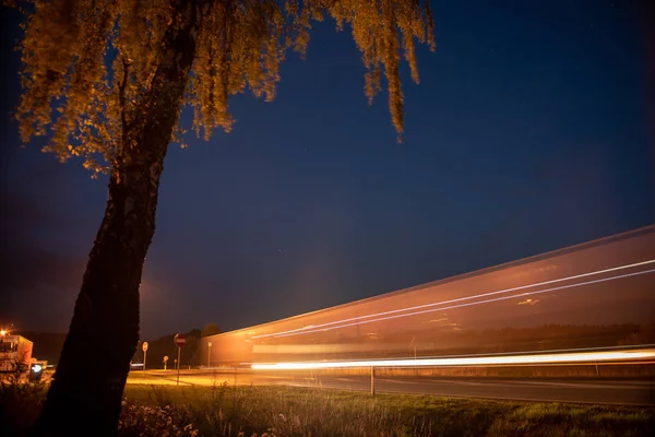 Teherautó fénynyomok az autópályán. Művészi kép. Az autópályán készült hosszú expozíciós fotó — Stock Fotó