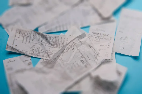 Pile of shopping receipts on blue background — Stock Photo, Image