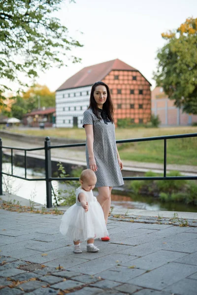 Happy family mother and child little daughter running and playing on autumn walk — Stock Photo, Image