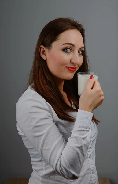 Menina alegre segurando caneca de leite na mão — Fotografia de Stock