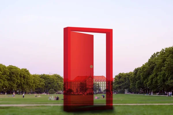 Semi transparent opened red door at the city park. Szczecin — Stock Photo, Image