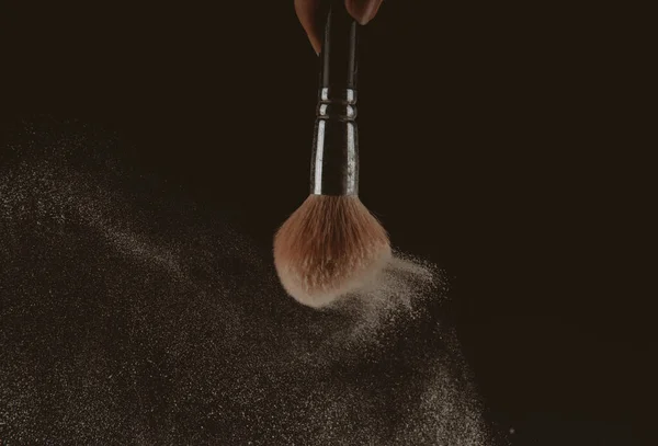Isolated make-up powder with brush on black background — Stock Photo, Image