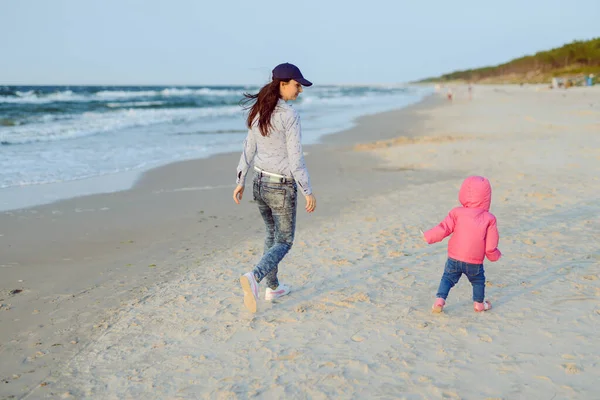 Moeder en dochtertje spelen op het strand. Authentiek beeld — Stockfoto