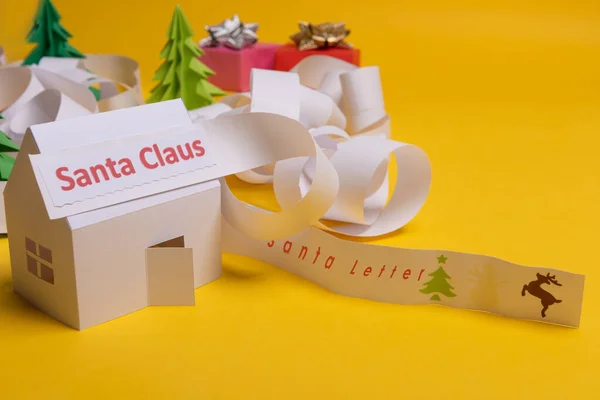 Long twisted expanded letter for Santa Claus. Copy space. yellow background.