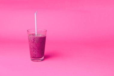 Pembe arka planda kahvaltıda taze böğürtlen, chia tohumu ve muz ile yabanmersini smoothie, seçici odak