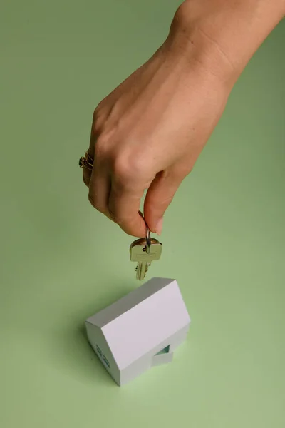 Weißes Familienpapierhaus Hausschlüssel Der Hand Auf Minzpapier Minimalistisches Und Einfaches — Stockfoto