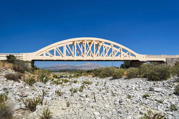 A road arched bridge over a dried river on the island of Rhodes