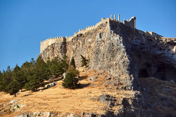 Medieval walls and antique columns on the top of the rock in the city of Lindos