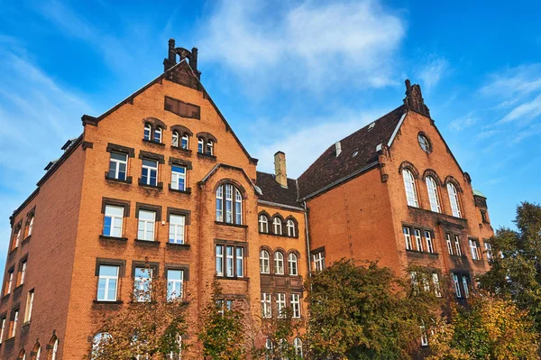 a red brick university building in Poznan