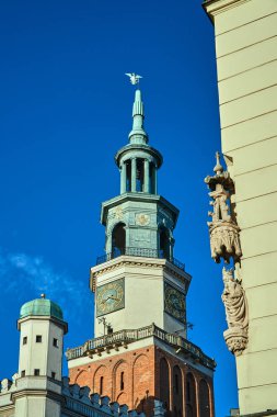 Poznan'daki evin köşesinde ve belediye binasının kulesinde bir taş figür