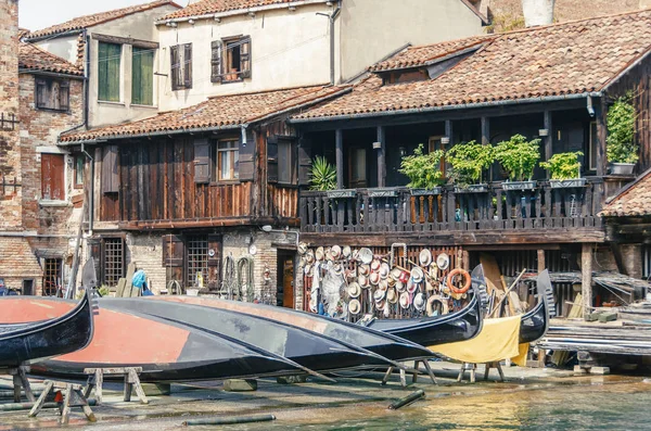 Old boat repair yard in Squero de San Trovaso. Gondola repair dock in Venice, Italy. Retro stylized photo
