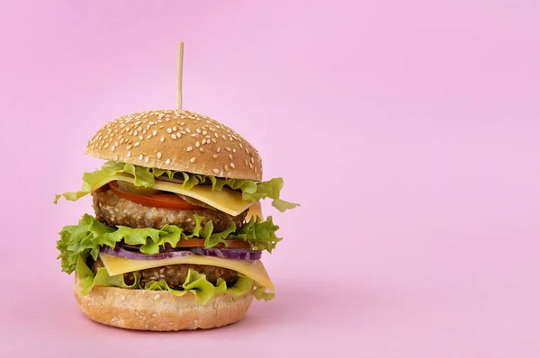 Double cheeseburger on pink background