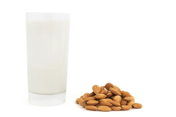 Glass of almond milk with heap of nuts isolated on white. — Stock Photo, Image