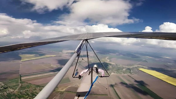 Hang glider pilot race between clouds on high altitude. — Stock Photo, Image