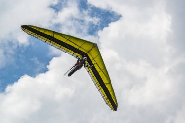 Arka planda bulutlu gökyüzü olan sarı planör kanadı. 