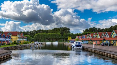 Boats and cottages in the port Rheinsberg near Berlin clipart