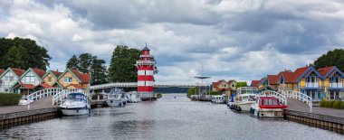 Boats and cottages in the port Rheinsberg near Berlin clipart