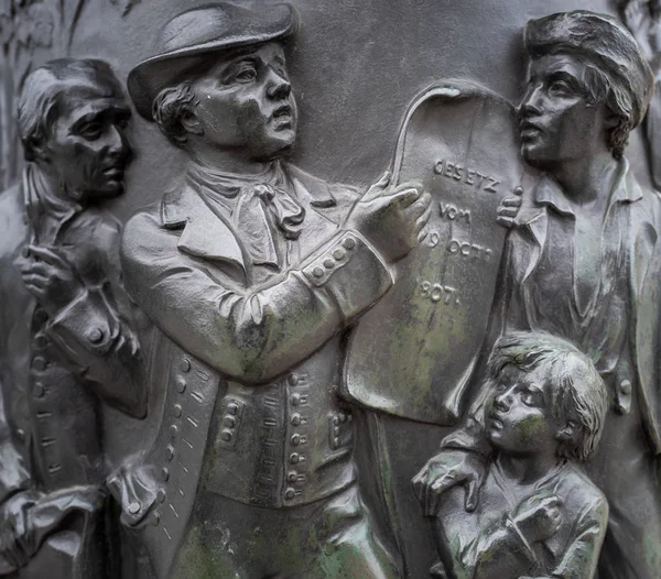 Bronze sculpture from the October edict on a statue in Berlin, Germany — Stock Photo, Image