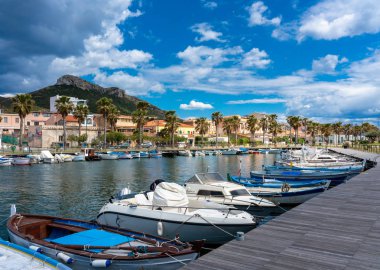 The port of figari with fishing boats and barges at Golfo Aranci in Sardinia, Italy clipart