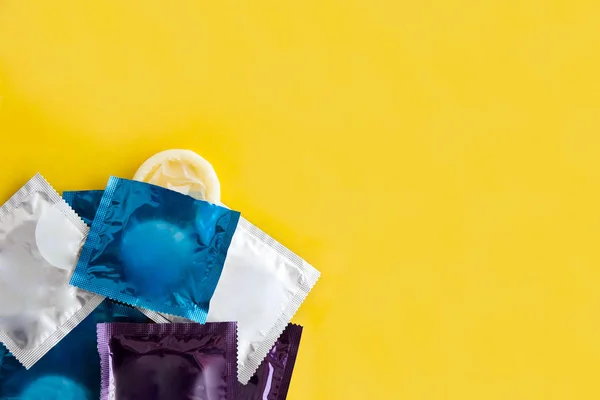 Close Multi Colored Condoms Yellow Background — Stock Photo, Image