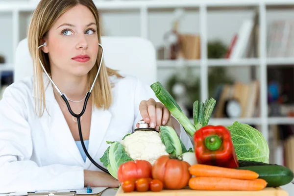 Tiro Belo Jovem Nutricionista Ouvindo Com Estetoscópio Legumes Consulta — Fotografia de Stock