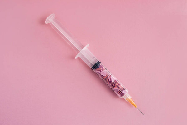 Syringe a full of sugar isolated on pink. Concept of diabetes. 