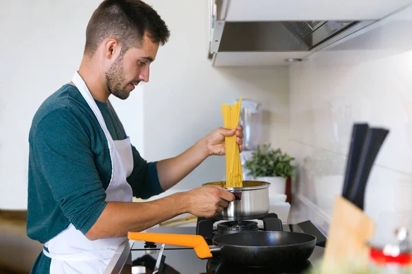 Portrait Handsome Young Man Cooking Pasta Kitchen Home — Stock Photo, Image