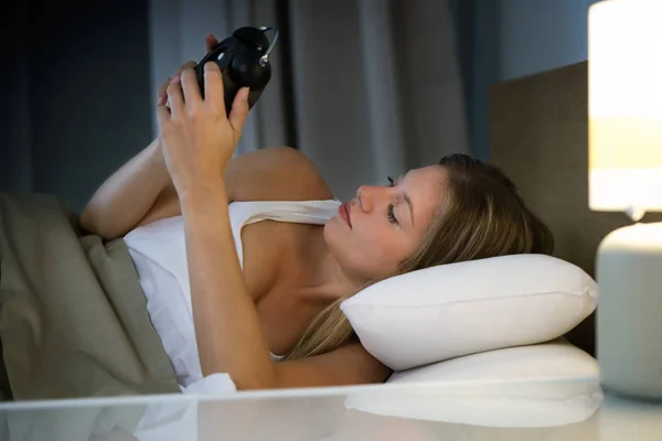 Shot Beautiful Young Exhausted Woman Suffering Insomnia Holding Looking Clock — Stock Photo, Image