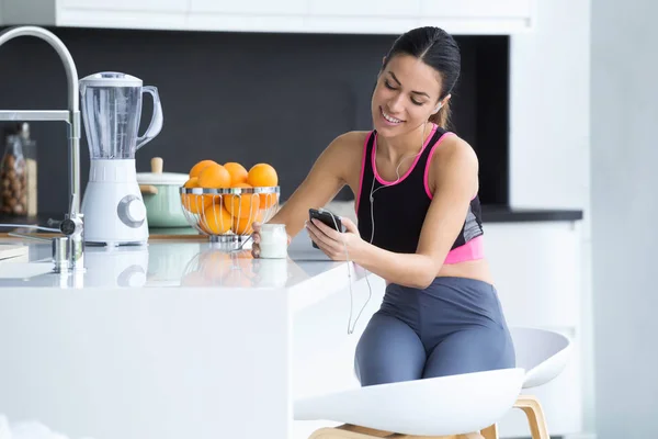 Atış Sportif Genç Kadın Mutfakta Evde Yoğurt Yerken Cep Telefonu — Stok fotoğraf