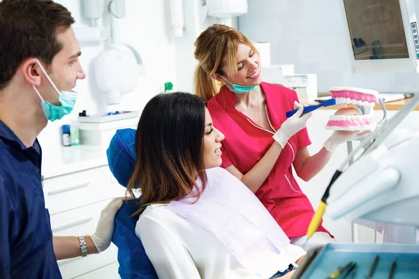 Foto Hermoso Dentista Explicando Cómo Cepillar Los Dientes Correctamente Paciente —  Fotos de Stock