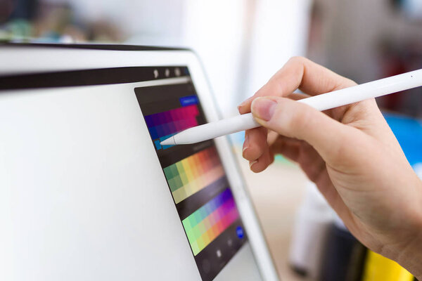 Young designer woman hand working with her digital tablet at the office.