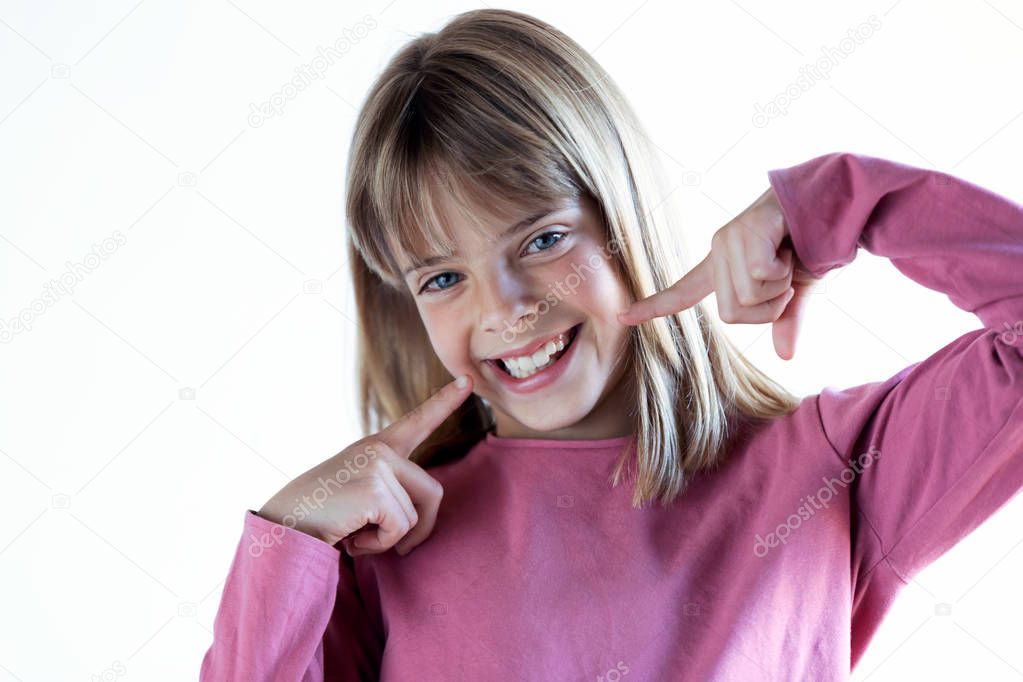 Pretty blonde little girl with perfect smile looking at camera. Isolated on white background.