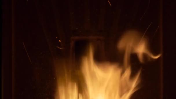 Close-up of warm cozy burning fire in a brick fireplace. Black background. — Stock Video