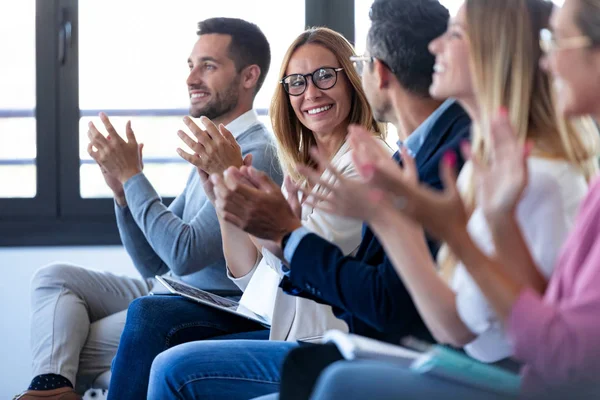 Happy business team clapping after listening the conference while sitting on coworking space. — Stock Photo, Image