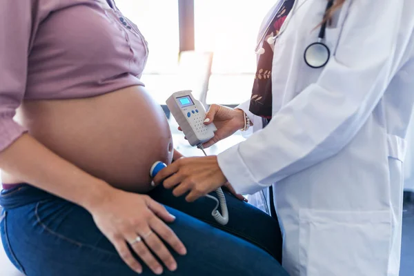 Obstetrician gynecologist performing Doppler auscultation checking blood flow in placenta and uterus in the clinic. — Stock Photo, Image