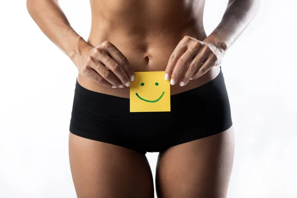 Una giovane donna con un segno di sorriso sullo stomaco. Igiene sanitaria concetto di educazione sessuale . — Foto Stock