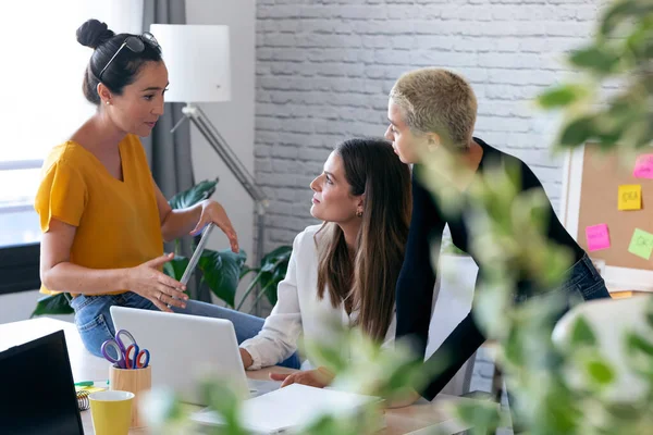 Tre imprenditrici moderne che parlano di nuove idee per il prossimo lavoro in uno spazio di lavoro congiunto . — Foto Stock