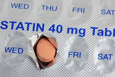 A statin tablet emerging from  a  marked weekly blister pack clipart