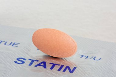 Close up of a Statin Tablet on a Blister Pack. Medication and Health concept clipart