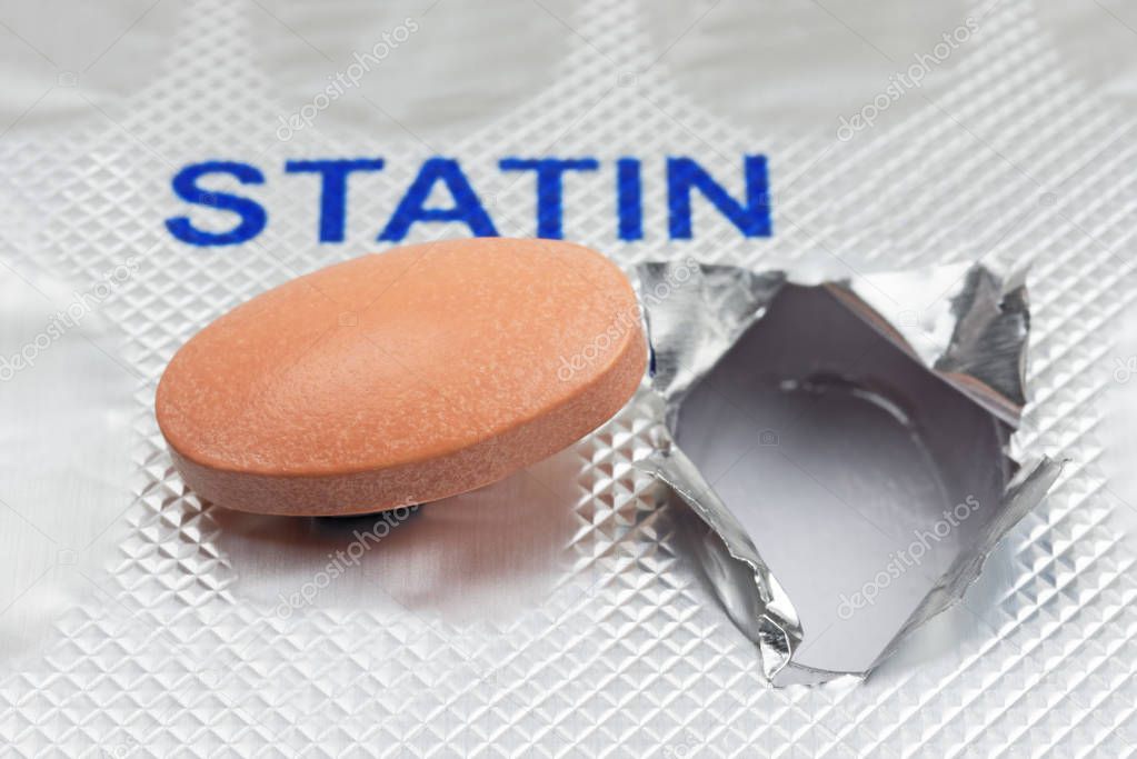 Close up of a generic statin tablet on a blister pack. Shallow depth of field. Logos removed