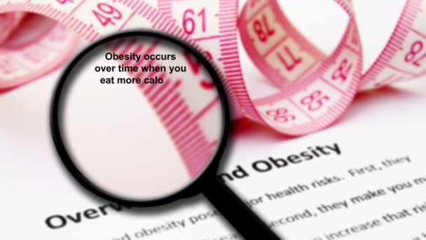 Magnifying glass on overweight and obesity concept — Stock Video