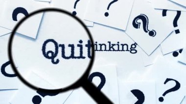 Magnifying Glass Searching for Quit Drinking Among Question Marks and Words