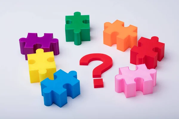 Red Question Mark Sign Surrounded Multicolored Jigsaw Puzzle — Stock Photo, Image