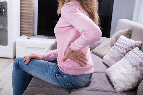 Mature Woman Sitting Sofa Suffering Backache Home — Stock Photo, Image